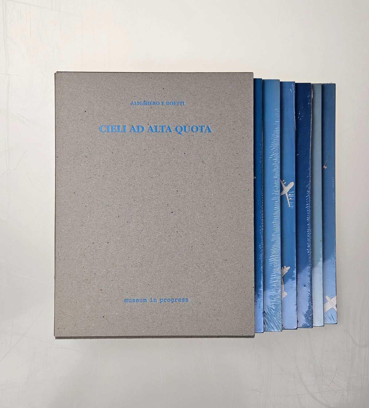 Grey cardboard box with the six iconic puzzles Cieli ad alta quota by Alighiero Boetti from the year 1992/1993. 